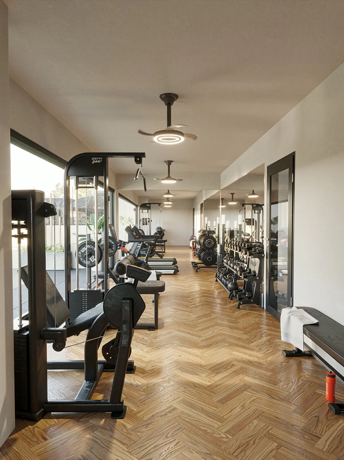 Gimnasio equipado con piso de madera y ventanales